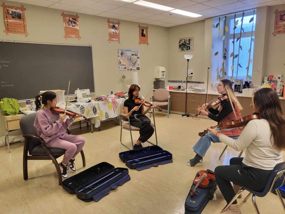 Simara Wilson, second from right, teaches the fiddle to northern youth. Photo: Simara Wilson