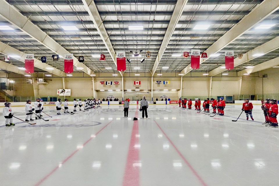 Players line up for the national anthem ahead of a "global game" at Yellowknife's multiplex. Ollie Williams/Cabin Radio