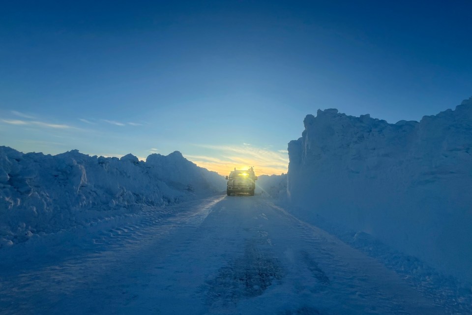 A vehicle on the Inuvik-Tuk Highway as work continues to clear snow from the road in February 2024. Photo: Brad Olson