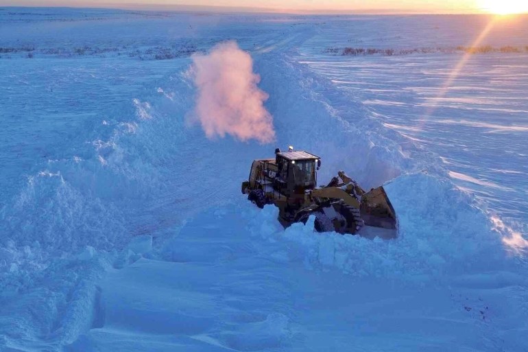 Clearing snow from the Inuvik-Tuk highway. Photo: Branden Walker