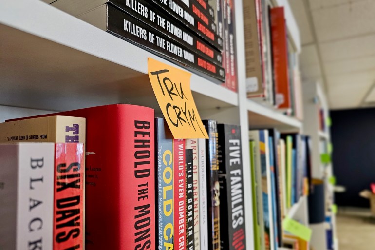 A sticky note acts as a temporary guide to which books are where. Ollie Williams/Cabin Radio