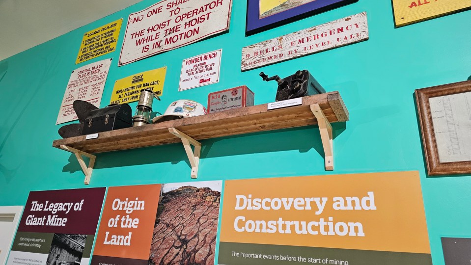 Mining ephemera above museum displays about Giant Mine's legacy.