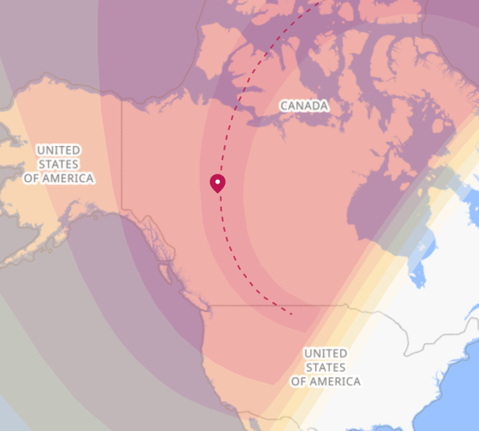 A timeanddate.com map of the 2044 solar eclipse path. The darkest red line is the path of totality. The red marker is Fort Simpson.