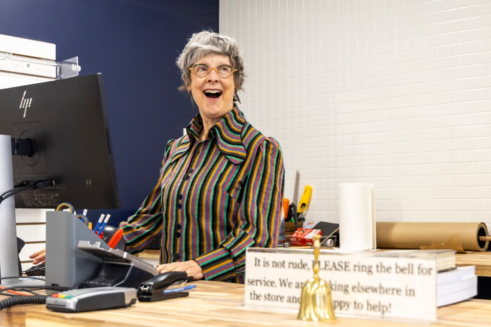 Catherine Pigott behind the counter at the new Book Cellar. Ollie Williams/Cabin Radio