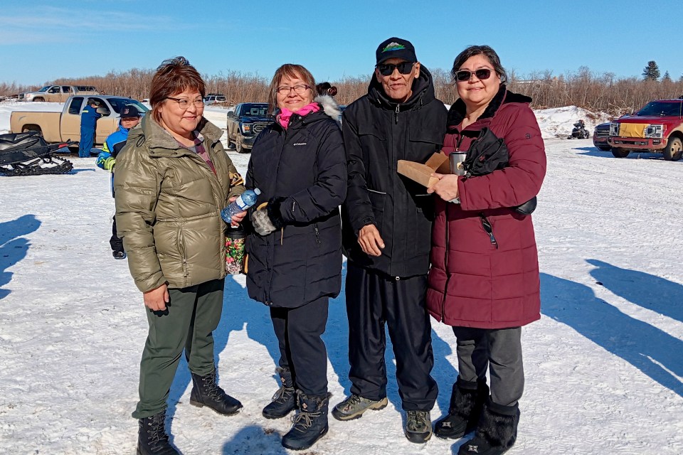 Verna Itsi (left) is known by her friends as "Little chainsaw Verna" for her log cutting skills. This year, Verna came in second place at Fort McPherson's Peel River Jamboree. Chloe Williams/Cabin Radio