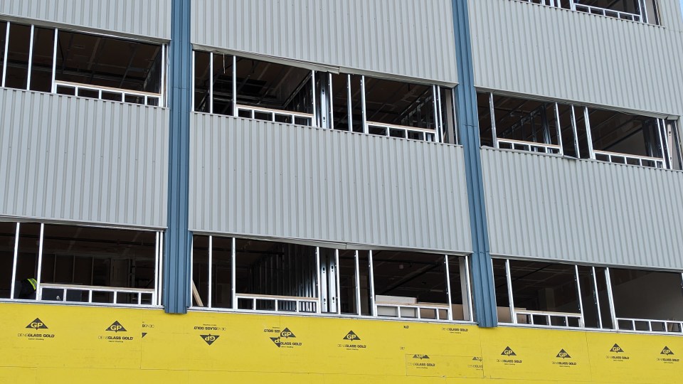 The windows have ben removed from the Bellance building as part of its transformation into the Nest apartment and retail complex. Sarah Pruys/Cabin Radio