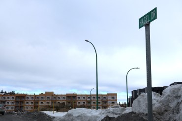 Hagel Drive in April 2024, where a 70-unit housing project is already under construction and another development is proposed. Emily Blake/Cabin Radio
