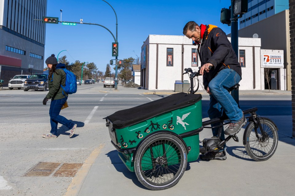 Adam Denley and his cargo bike. Ollie Williams/Cabin Radio