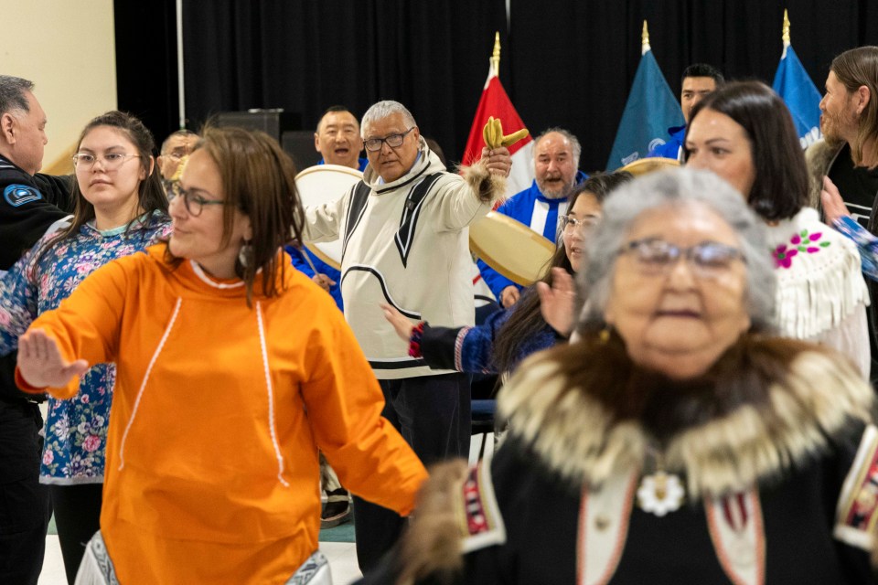 Gerry Kisoun, centre in white, dances ahead of his swearing-in as Commissioner of the Northwest Territories in Inuvik on May 14, 2024. Ollie Williams/Cabin Radio