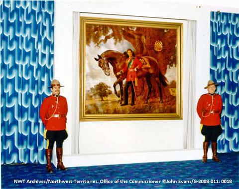 Two Royal Canadian Mounted Police officers stand at attention on either side of the newly unveiled portrait of HRH Prince Charles in the Katimavik Rooms of the Explorer Hotel in 1979 John Evans/NWT Archives