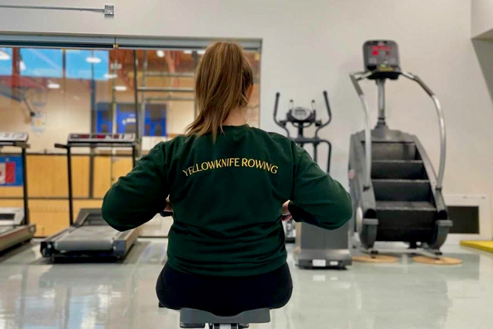 An athlete on a rowing machine wearing a Yellowknife Rowing top. Photo; Submitted