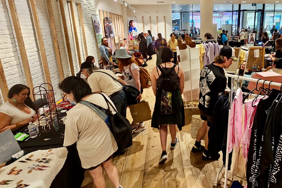 Stalls at the Indigenous Fashion Arts Festival Marketplace in Toronto's Eaton Centre on June 1, 2024. Ollie Williams/Cabin Radio