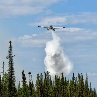 A photo published by NWT Fire shows an aircraft battling fire VQ001 in June 2024.