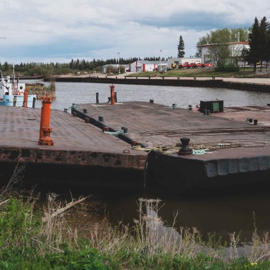 Barges sit idle in Hay River in June 2024. Sarah Pruys/Cabin Radio