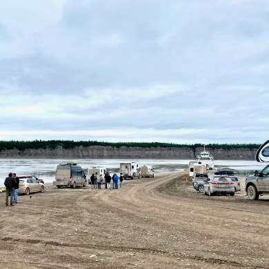 Vehicles wait for the Tsiigehtchic ferry crossing to resume. Photo: Tyler Gregory