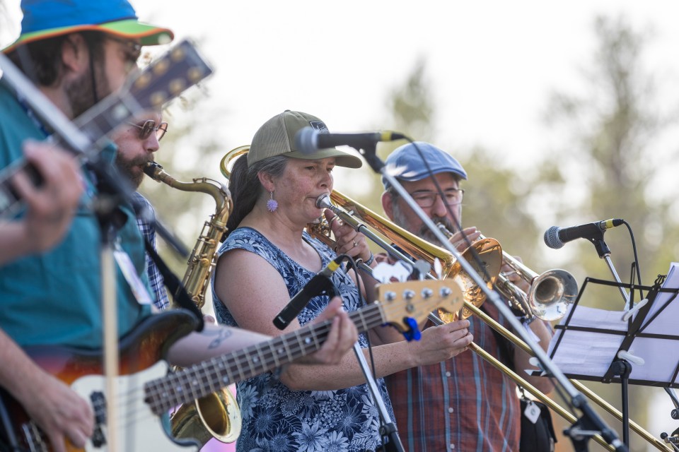A miniature brass section from the Ragged Ass Swing Band guests with Nix & Menno in the beer garden on July 21, 2024. Ollie Williams/Cabin Radio