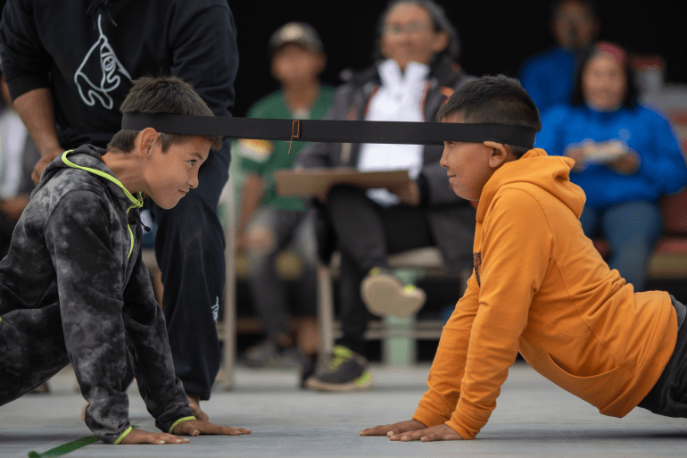 Participants in the 2023 Northern Games head pull event. The head pull is a game of strength and endurance. Photo: Inuvialuit Communications Society