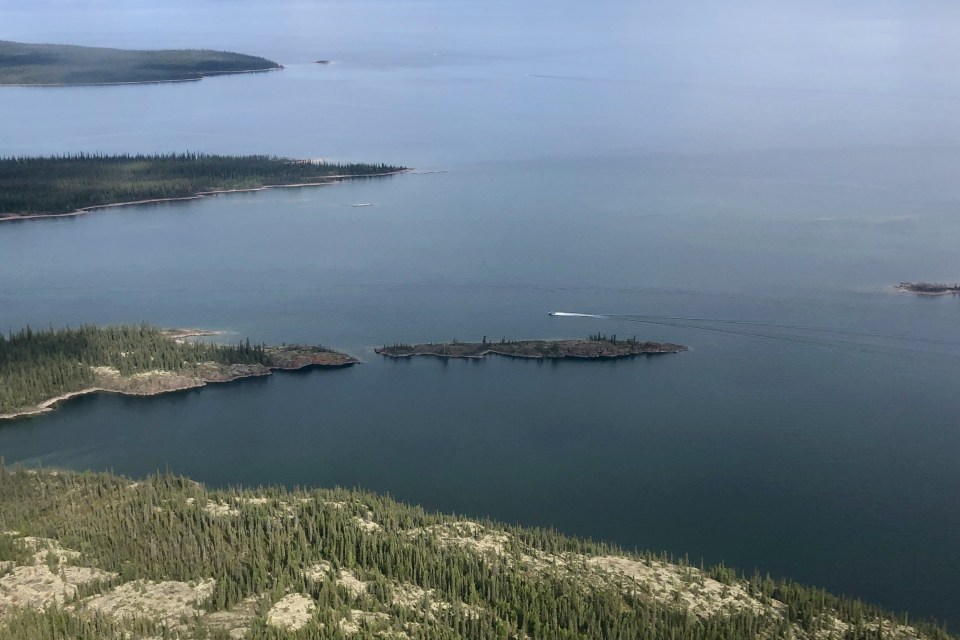 A boat takes off on Great Slave Lake outside Łútsël K'é. Emily Blake/Cabin Radio