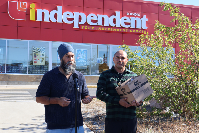 Jagmeet Singh and Kelvin Kotchilea address reporters outside one of Yellowknife's Independent grocery stores in August 2024. Caelan Beard/Cabin Radio