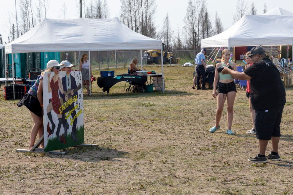 Attendees pose behind a jamboree sign. Ollie Williams/Cabin Radio