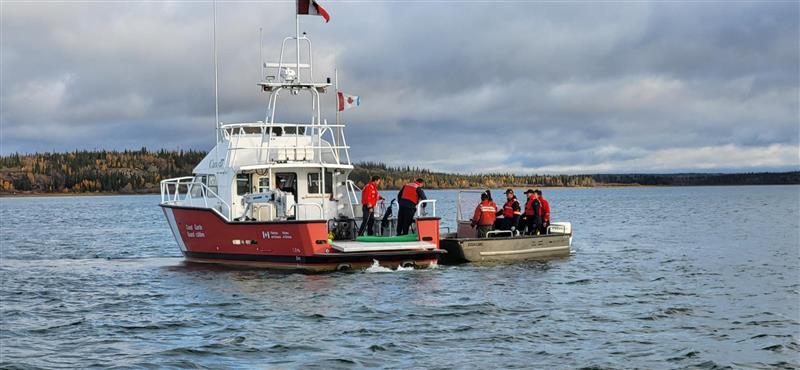 A crew on a boat working to recover the sunken vessel. Photo: Canadian Coast Guard