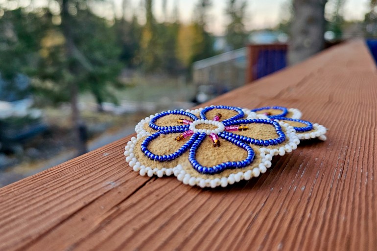 Beaded flower earrings made by Elsie Marcellais. Ollie Williams/Cabin Radio