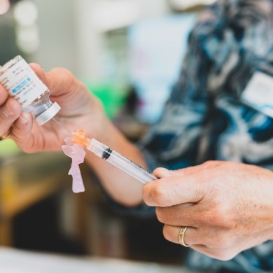 A vaccine is prepared at a Yellowknife flu and Covid-19 immunization clinic in November 2024. Sarah Pruys/Cabin Radio