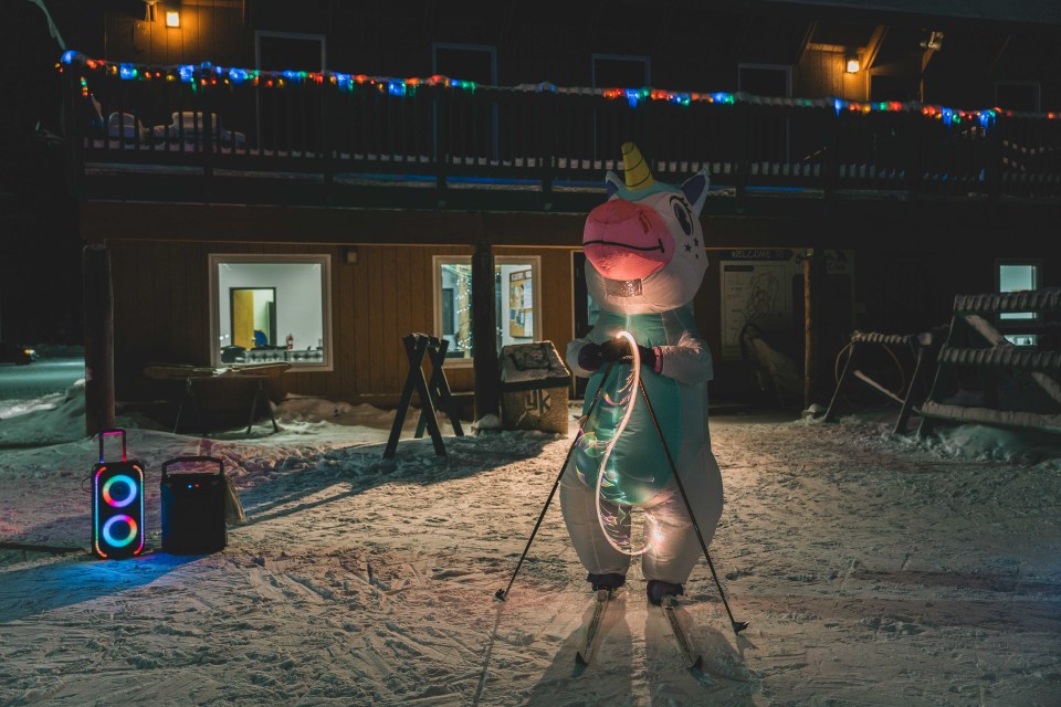 Unicorn Natasha McCagg twirls a fibre optic light. Sarah Pruys/Cabin Radio