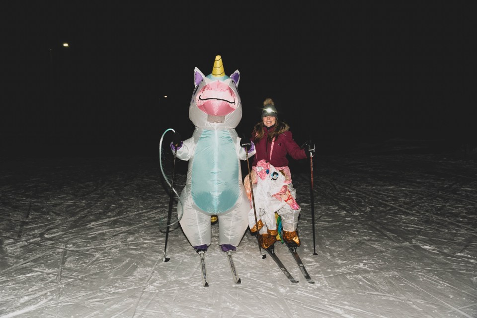Inflated unicorn Natasha McCagg and deflated unicorn Natasha Welsht pose in the Yellowknife Ski Club's stadium. Sarah Pruys/Cabin Radio