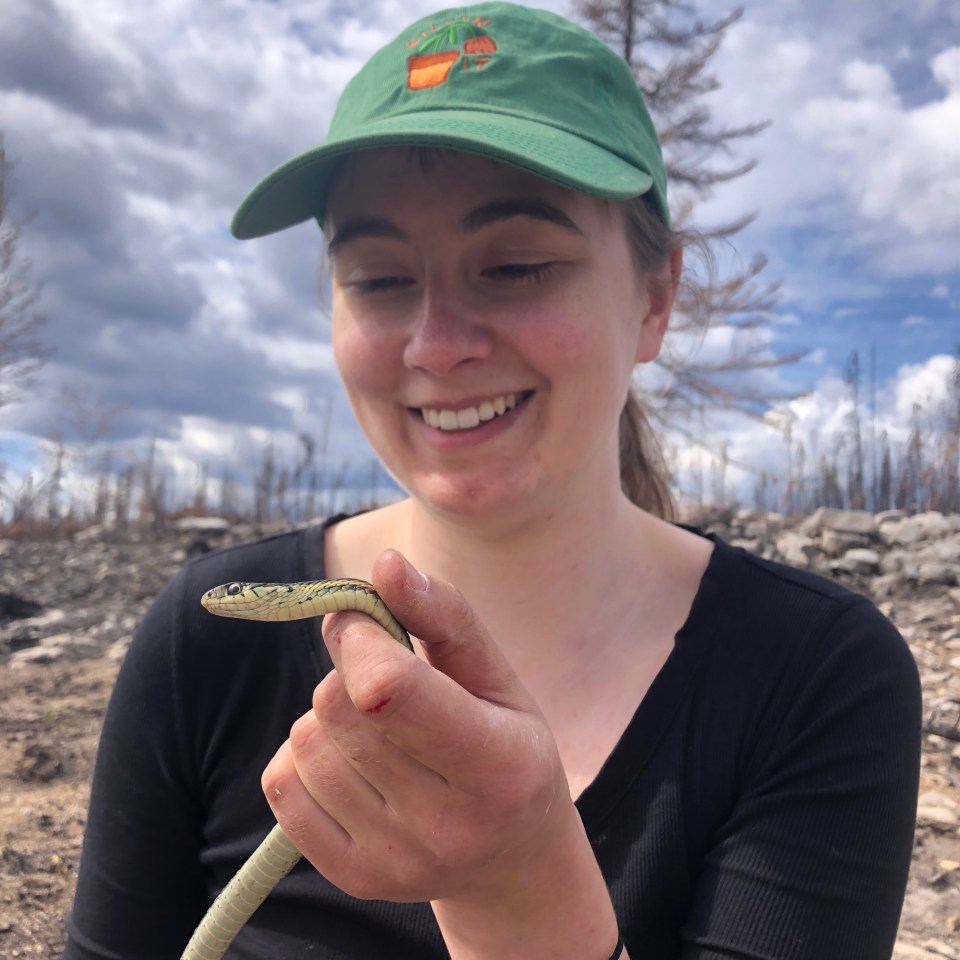 Johanna Stewart and a red-sided garter snake. Photo: Peter Lin