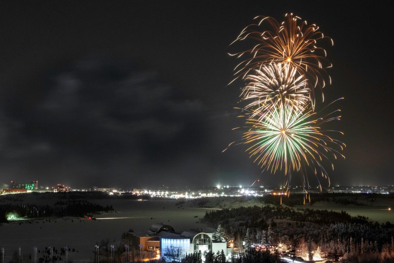 Fireworks over Yellowknife are seen from the Explorer Hotel on New Year's Eve 2024. Photo: Bill Braden