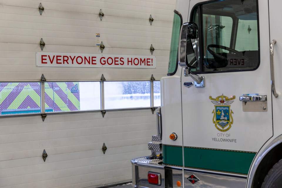 A sign on the door of Yellowknife's fire hall declares: "Everyone goes home." Ollie Williams/Cabin Radio