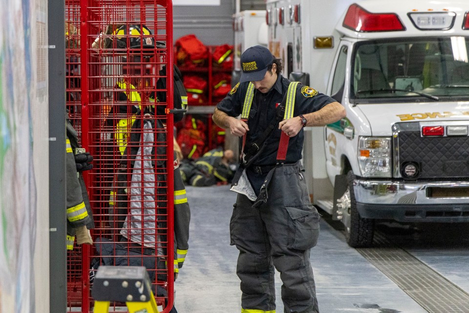 A firefighter prepares for a call in Yellowknife's fire hall. Ollie Williams/Cabin Radio