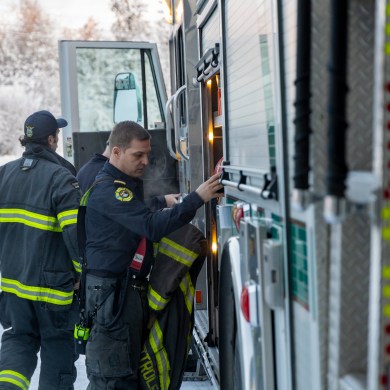 Firefighters prepare an engine at Yellowknife's fire hall in January 2025. Ollie Williams/Cabin Radio