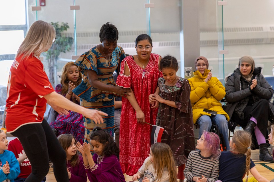 From left: teacher Georgette Konan with Gedulah Saif Anwar and Angerila Saif Anwar. Ollie Williams/Cabin Radio