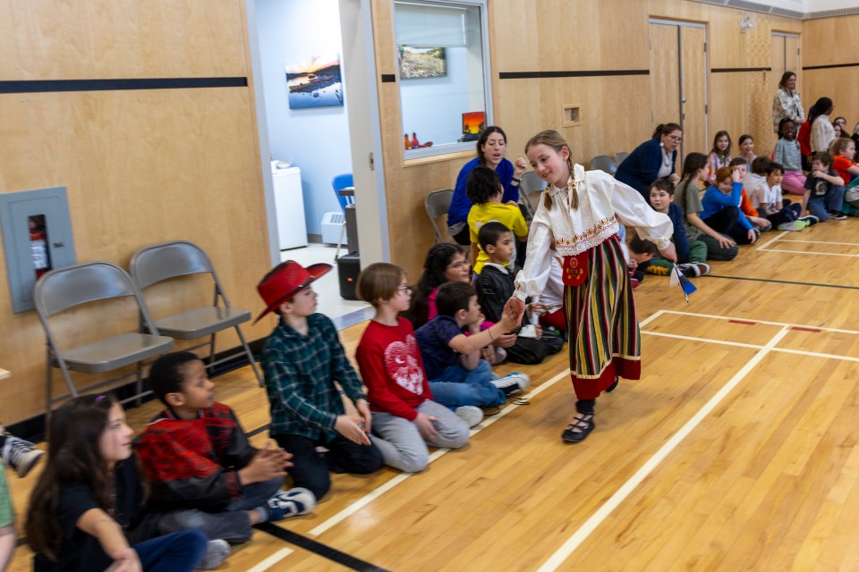 Lillia Drouin with the Estonian flag. Ollie Williams/Cabin Radio