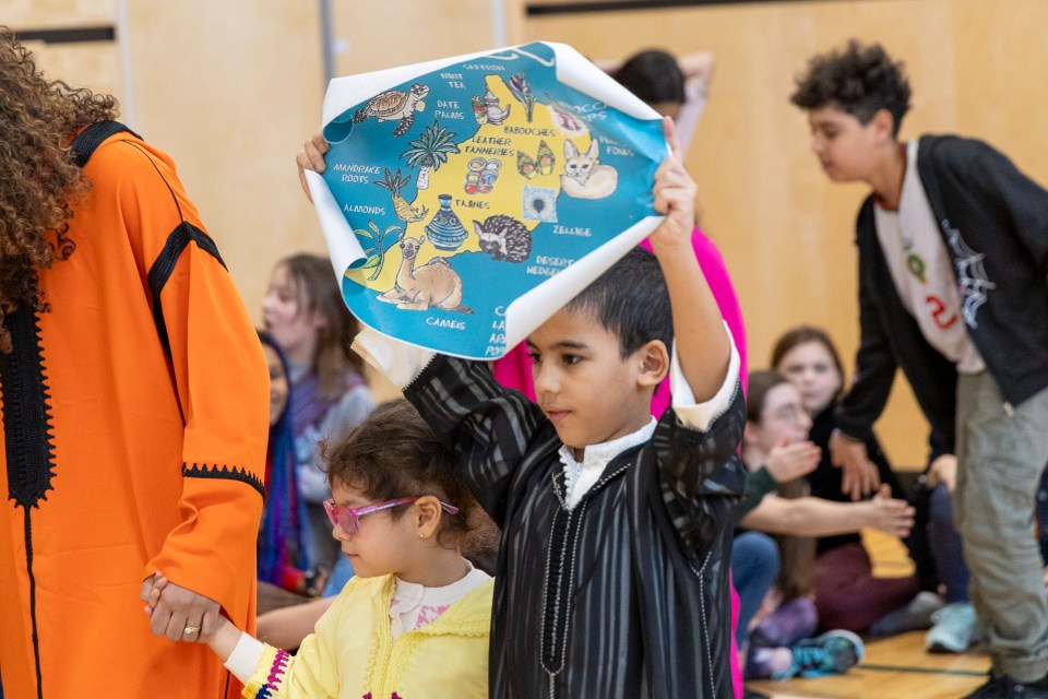 Mohamed-Ali Elbousstani holds a map of Morocco. Ollie Williams/Cabin Radio