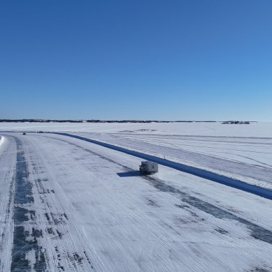 Vehicles travel on the ice road toward Dettah in March 2025. Sam Pitre/Cabin Radio