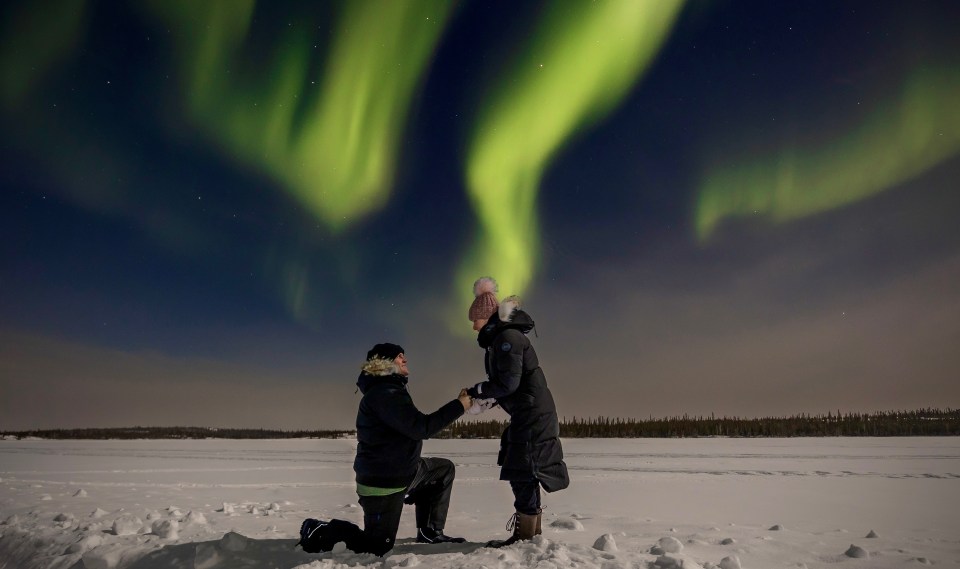 Mike Ogilvie proposes to Nicole Lacey under the northern lights in Yellowknife. Photo: Valerie Pond