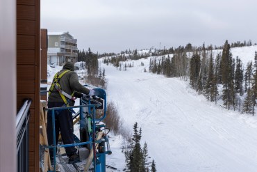 A worker puts final touches on The View, a new apartment building in Yellowknife. Ollie Williams/Cabin Radio