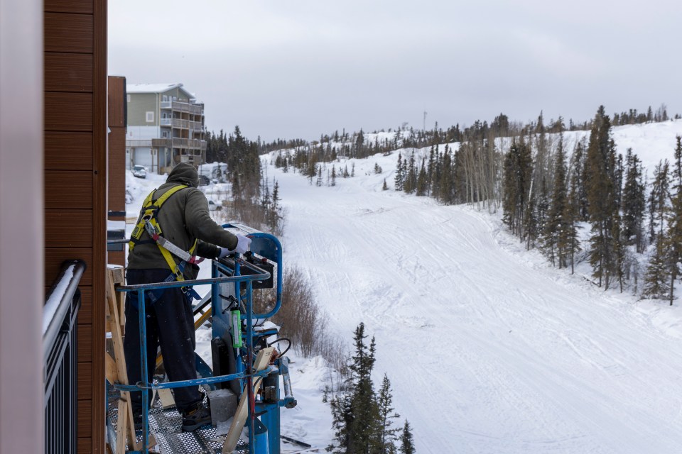 A worker puts final touches on The View, a new apartment building in Yellowknife. Ollie Williams/Cabin Radio