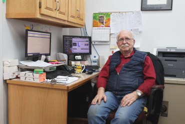 Brian Kovatch sits behind his desk at Superior Audio Video in Hay River. Claire McFarlane/Cabin Radio