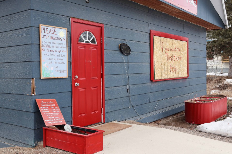 Signs posted at the Georgina's Place thrift store next to the Anglican church ask people to stop breaking in and to ask for what they might need instead. "No money is left here ... only love and dust ... because you already took the vacuum," reads one of the signs. Claire McFarlane/Cabin Radio