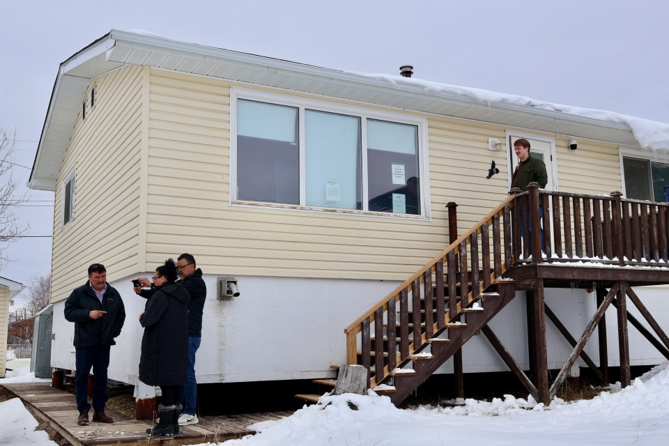 Sahtu MLA Danny McNeely, left, and Food Banks Canada representatives outside Norman Wells' food pantry building. Aastha Sethi/Cabin Radio