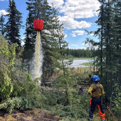 An NWT Fire image shows a crew working on the Tulip Lake wildfire in June 2025.