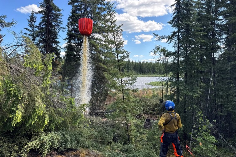 An NWT Fire image shows a crew working on the Tulip Lake wildfire in June 2025.