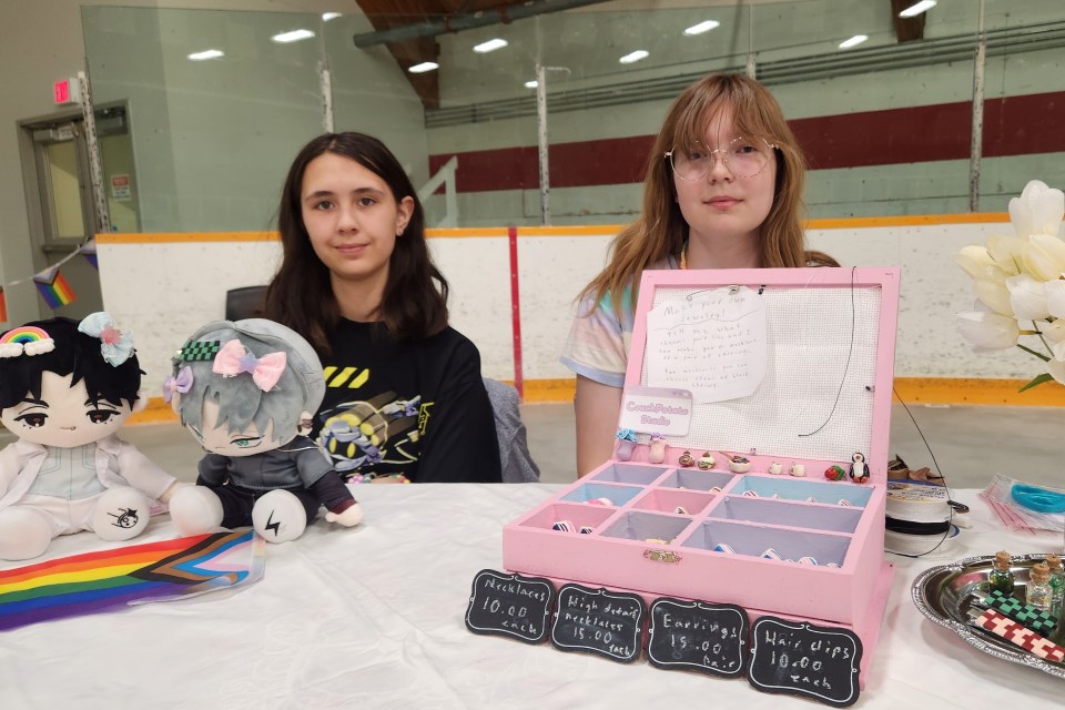 Holly Cochrane, left, and Emma Venema sell clay jewellery at the festival. Karli Zschogner for Cabin Radio