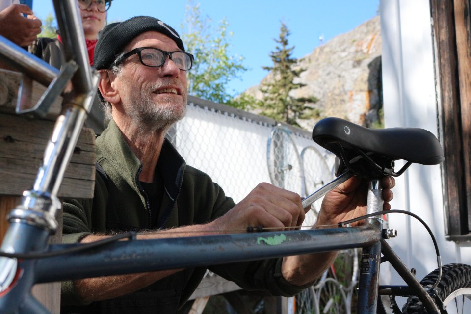 Matthew Grogono repairing a bike as part of the "Zen and the Art of Bicycle Recycling" workshop. Serra Hamilton/Cabin Radio