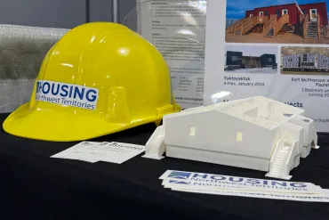 Items on display at a Housing NWT booth during the 2025 Arctic Development Expo in Inuvik. Ollie Williams/Cabin Radio