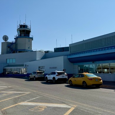 Taxis outside Yellowknife Airport in June 2025. Ollie Williams/Cabin Radio